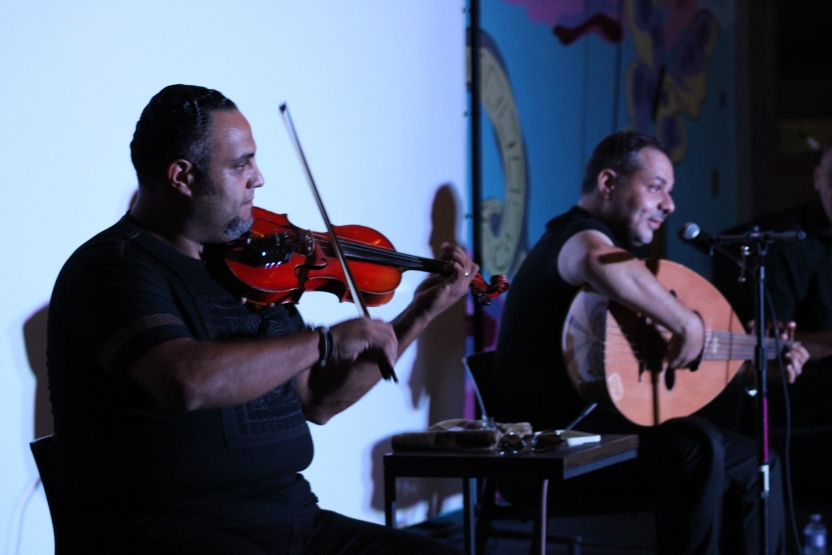Two students play music together. 