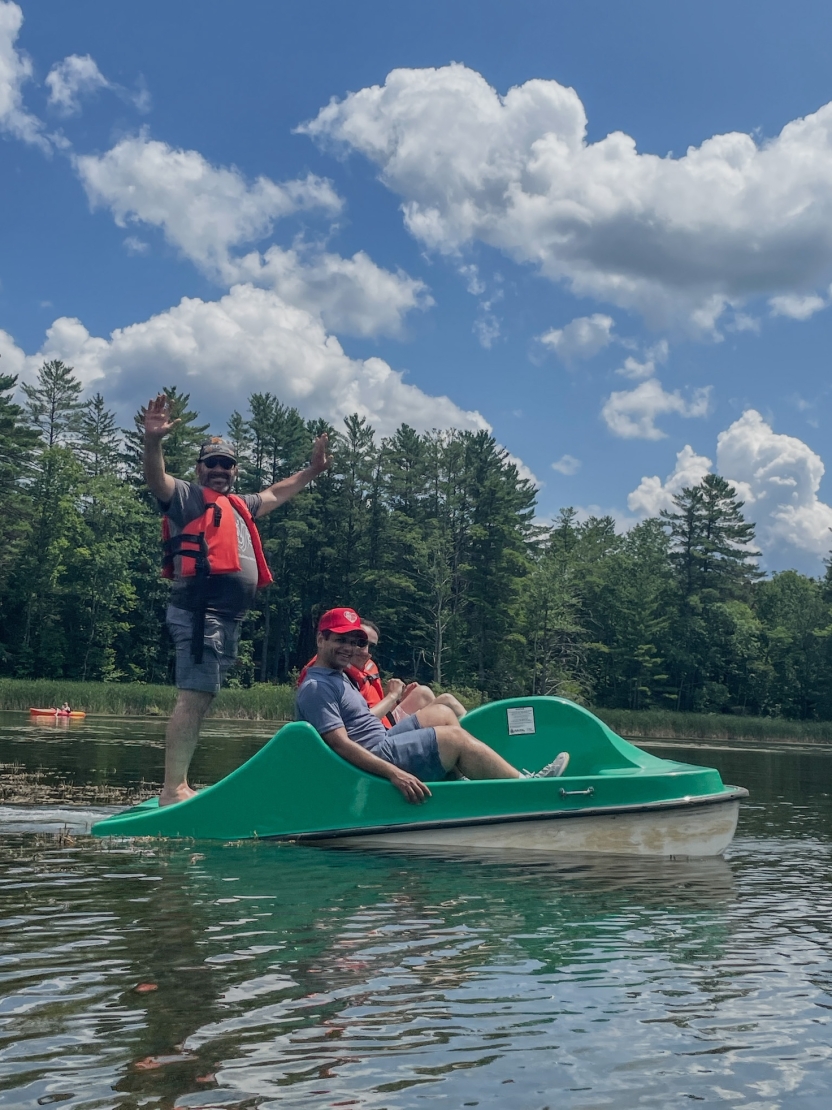Students use a paddle boat on the lake. 