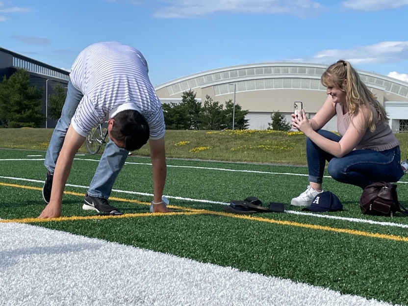A man at the starting line on an outdoor track. 