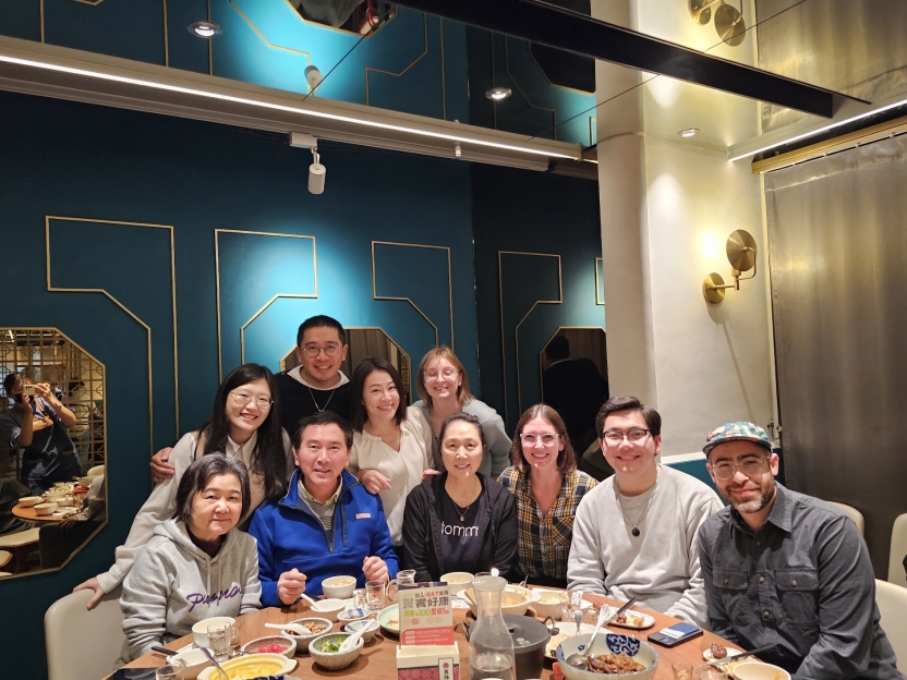 A group of people out to dinner together. 