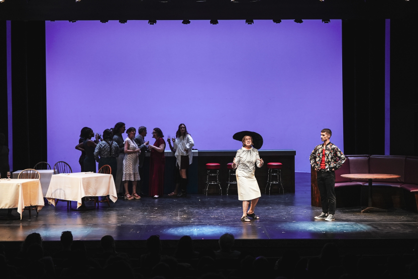 a woman performs in a play onstage. 