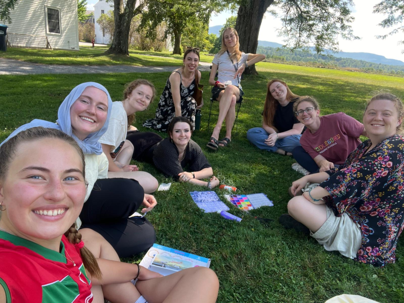 a group of friends in the grass.