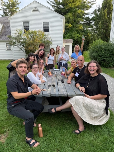 A group of Italian School students at a picnic table outside 