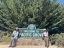 Students smile in front of a "Pacific Grove" sign. 