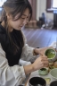 A student at the School of Japanese scoops tea. 