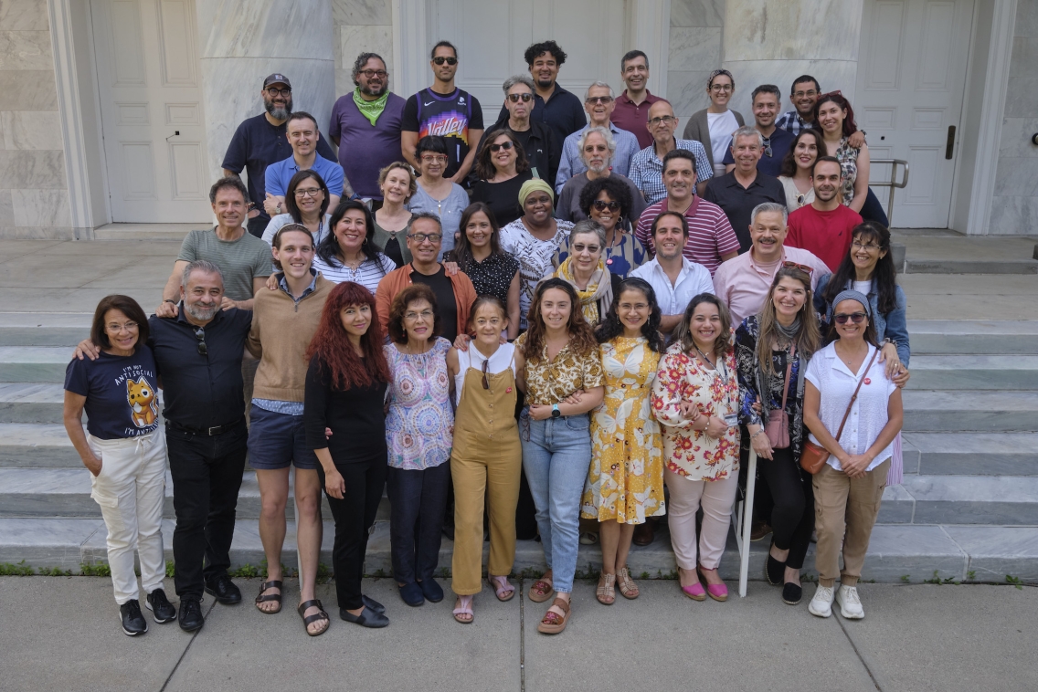 Spanish faculty stand side by side on the chapel steps. 
