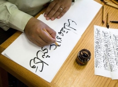 A student writes in calligraphy at the Middlebury Arabic Language School.
