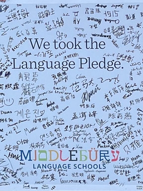 A poster signed by students who took the Language Pledge.