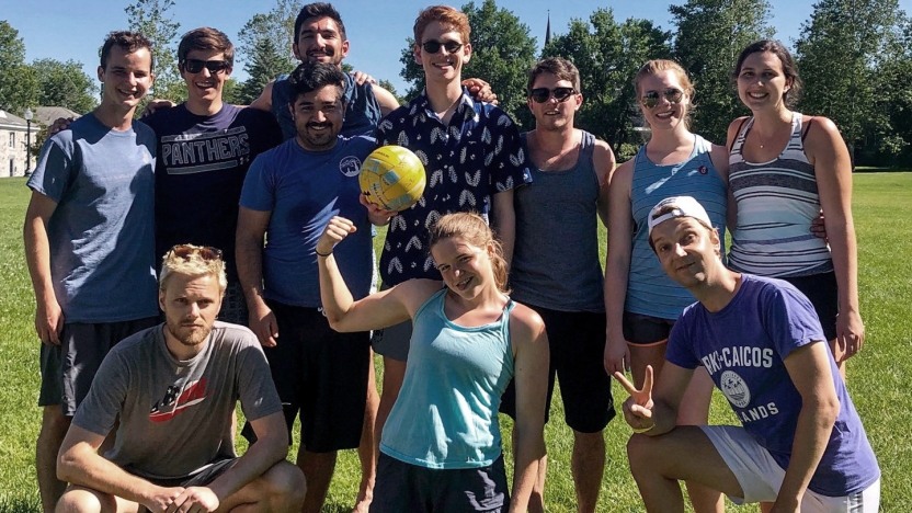 Intramural German School volleyball team pose for a photo on the court.