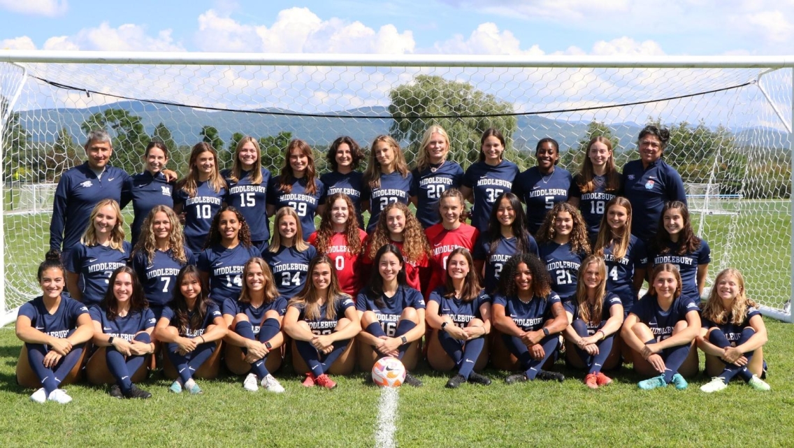 Photograph of the Middlebury College Women's Soccer team posing in front of a soccer goal.