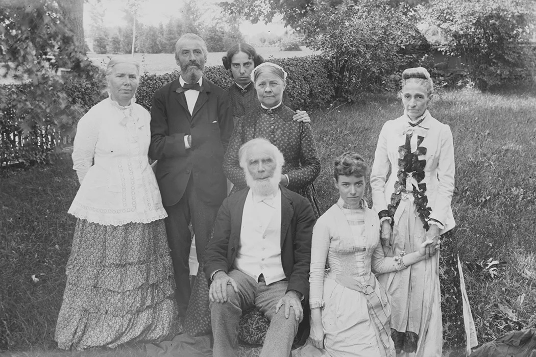black and white photo of seven people in a field