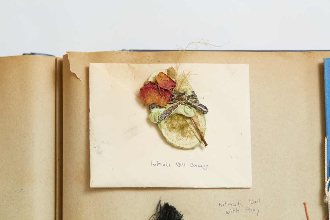 closeup of pressed flower corsage on brown paper