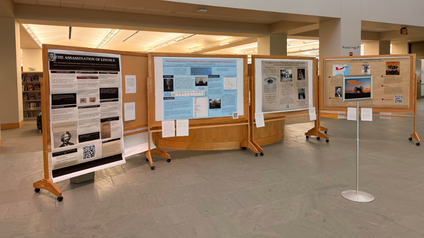 photo of 3 large posters on boards in lobby area