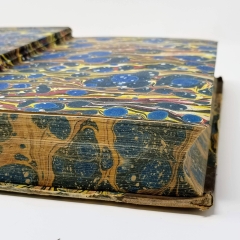 Book opened to reveal marbled endpapers