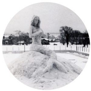 Black and white circular image of mermaid snow sculpture