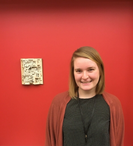 Portrait of Kaitlin Buerge in front of book sculpture 