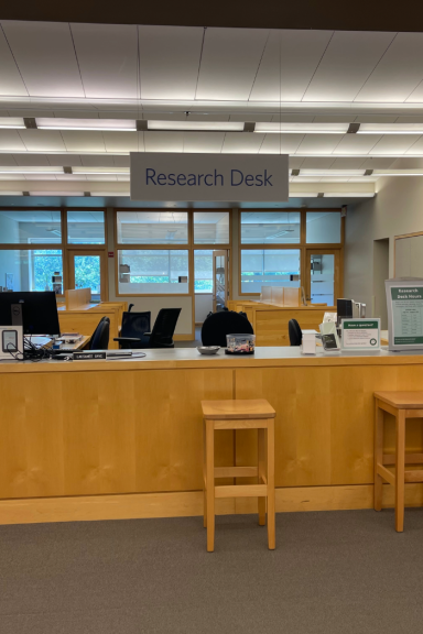 Photograph of service desk with "Research Desk" sign hanging above it
