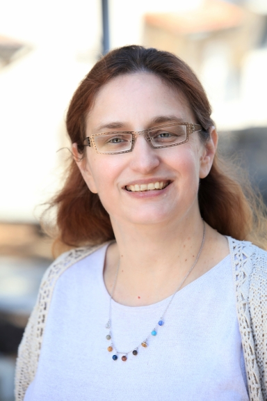 Image of woman in white shirt wearing glasses