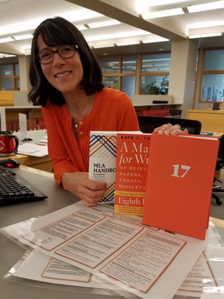 Photo of librarian, Carrie, with Citation manuals