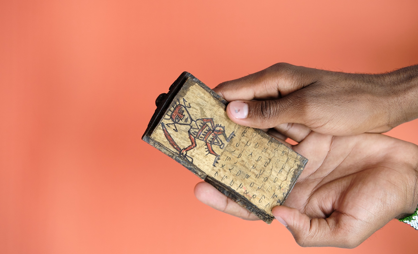 Student holds tiny book