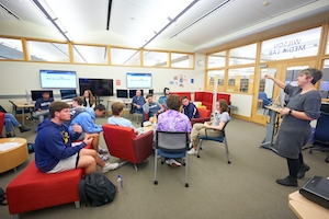 Librarian talking with students in computer lab