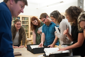 students looking at rare books in Special Collections