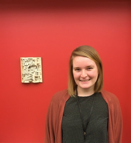 Portrait of Kaitlin Buerge in front of book sculpture