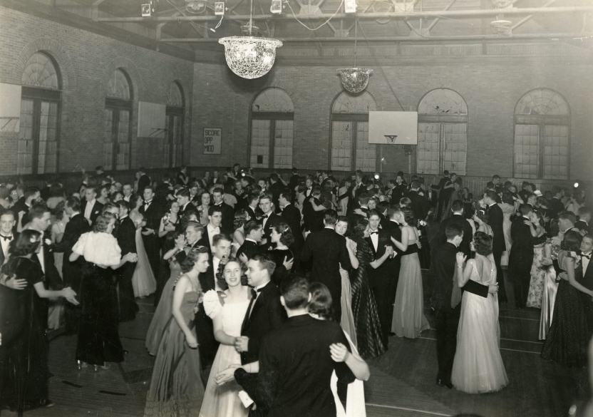 large crowd of students in formal attire dancing in gymnasium in McCullough