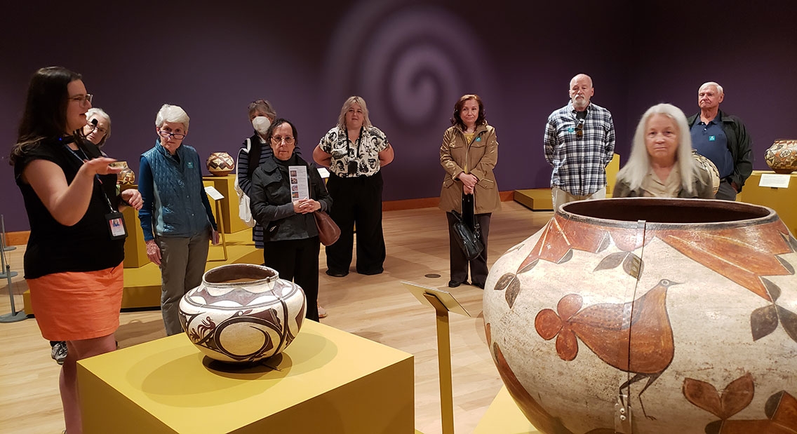 Members of the Friends of the Art Museum enjoy a tour of Native American pottery during a FOAM-sponsored trip to Shelburne Museum