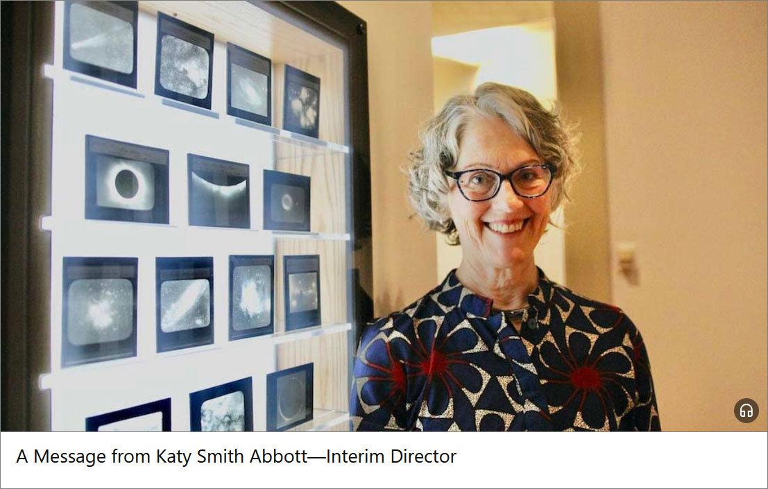 a woman stands in front of an array of photographs