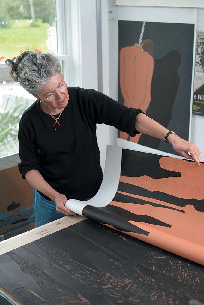 Sabra Field in her studio with various prints from the Pandora Suite