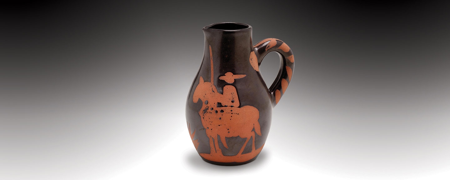 a red earthenware vase with black glaze depicting a picador on a horse