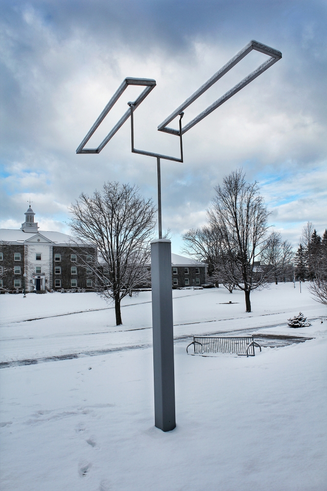 kinetic sculpture with two open metal rectangles which move with the wind but never touch or intersect