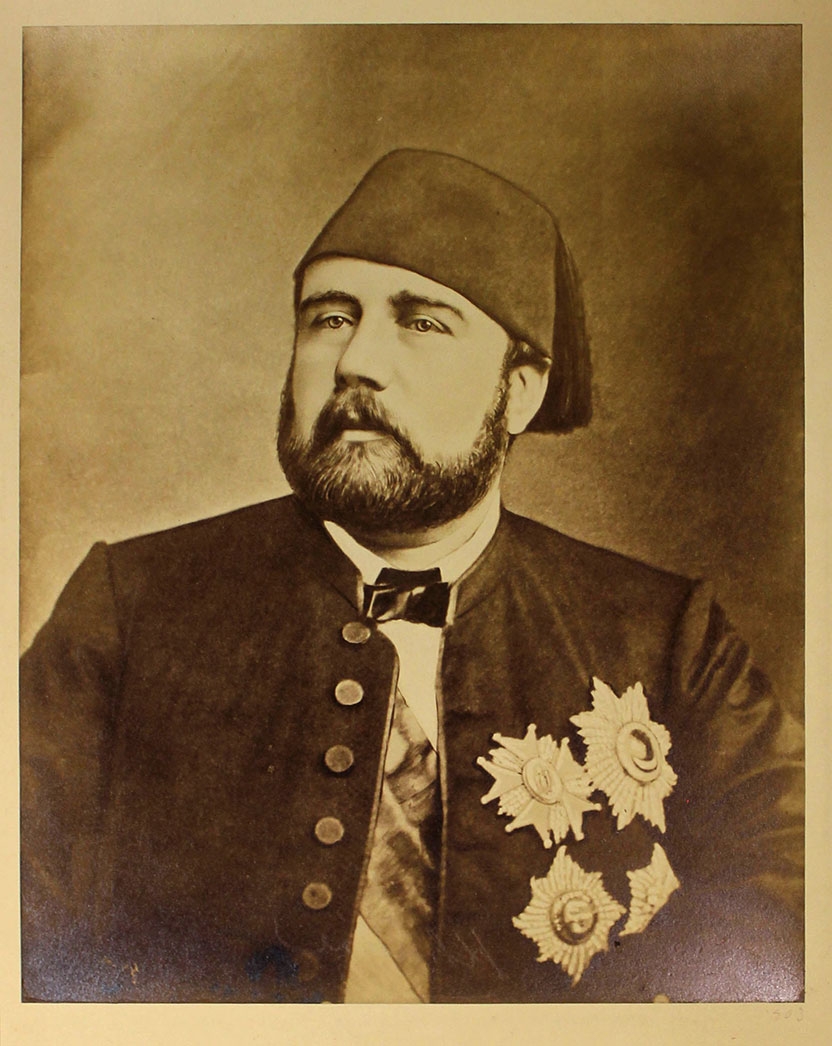 a sepia-toned photographic portrait of a bearded man in Ottoman attire