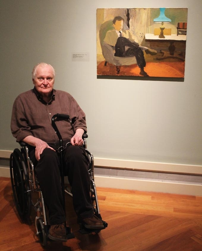 Poet John Ashbery poses in front of a Fairfield Porter painting for which he was the sitter