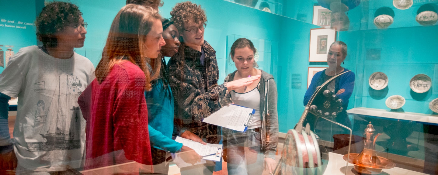 Students examine an ancient Chinese work of art for a class project.