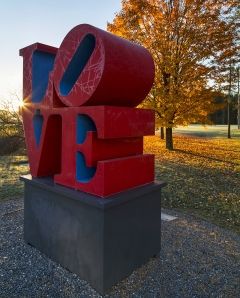 red and blue painted aluminum sculpture spelling the word LOVE
