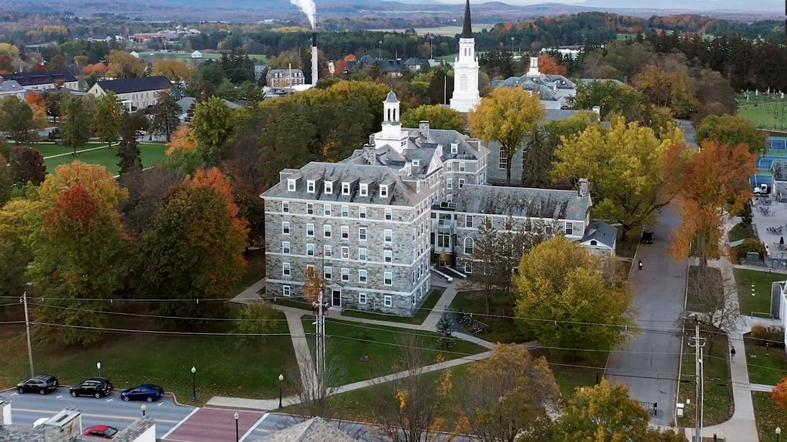 An aerial view of Middlebury College with the biomass plant in the background.