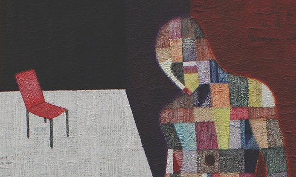 a bowed human figure in patchwork colors facing an empty red chair
