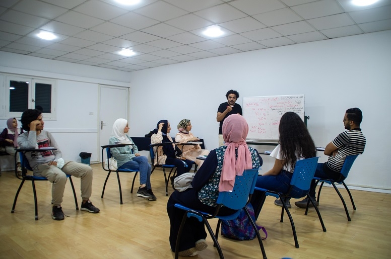 Saif Abdelrasol teaches students in a debate class