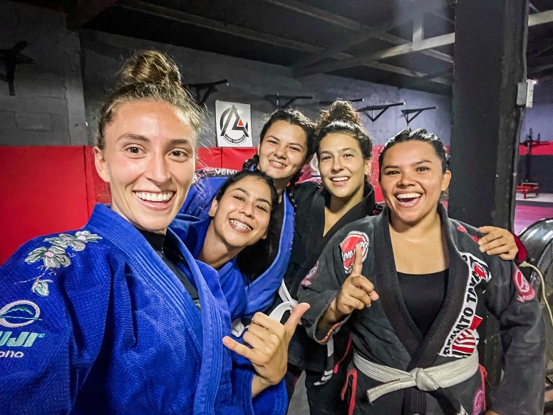 Shannon Casey poses with fellow jiu-jitsu students in their training room