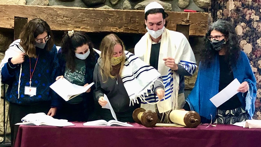 Middlebury students and Rabbi Stillman prepare to read from the Torah.