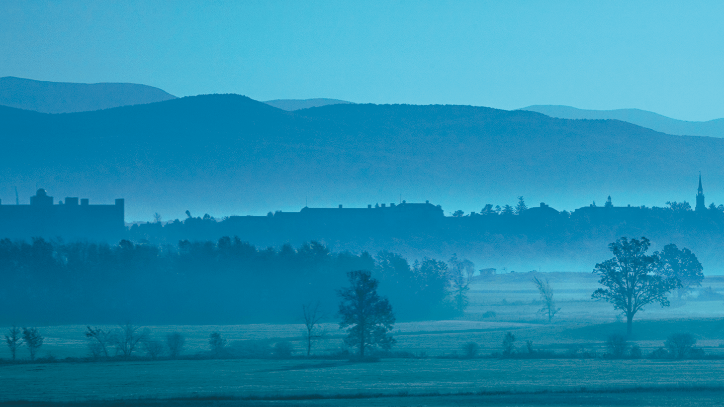 misty blue view of Middlebury's campus and the Green Mountains