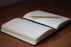 Open journal with a pencil