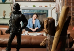 Photo of Julia Whelan in her home surrounded by art and sculptures 