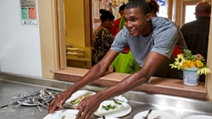 Midd student serving meals in Middlebury