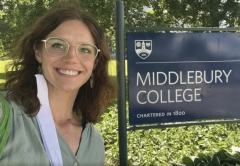 Photo of KWD scholar Madeline Doane nect to Middlebury College sign