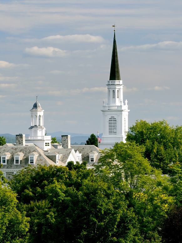 A view of the Middlebury College campus, including buildings and the Green Mountains in the background.