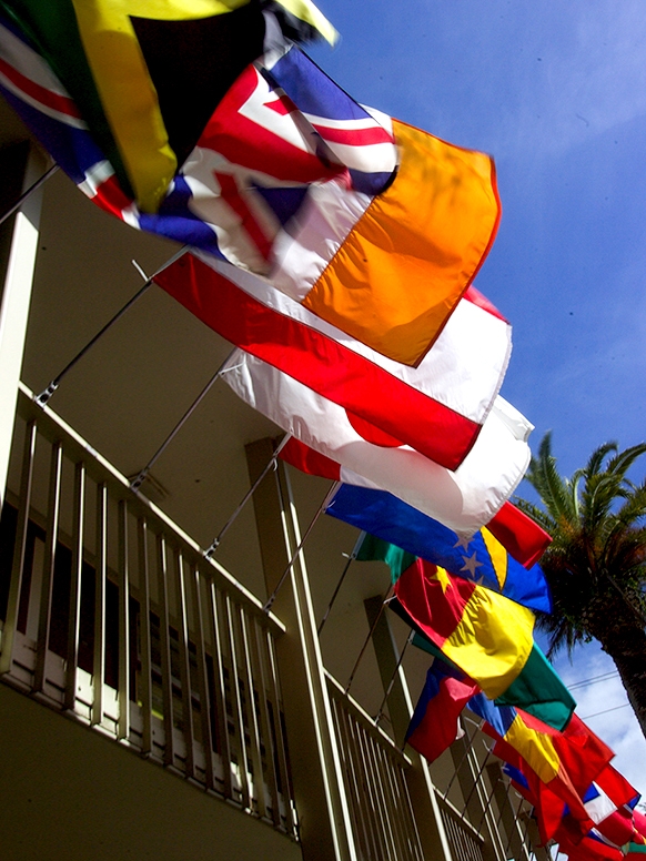 A cropped photograph of the many country flags flown on the buildings around the Middlebury Institute campus in Monterey, California.