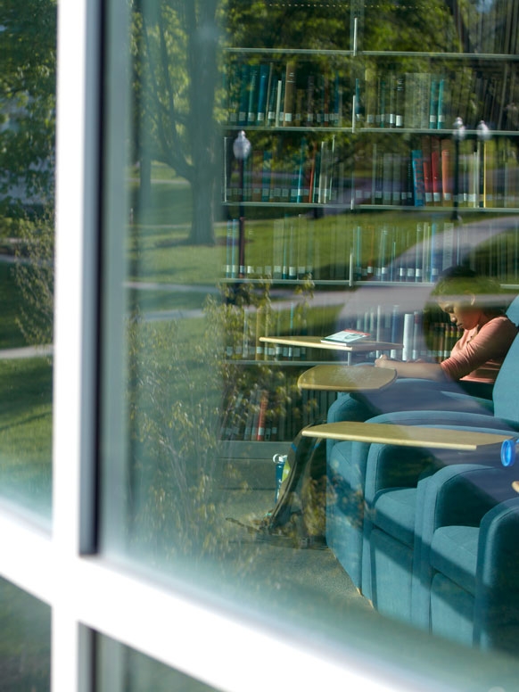 Looking through a window of the Davis library on campus.